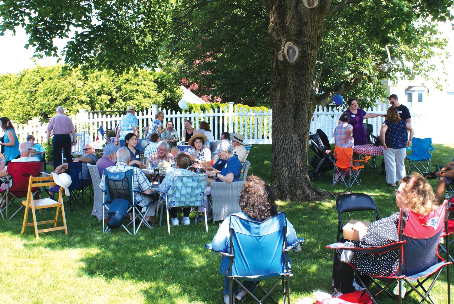 IT’S A PICNIC: Supportive friends, neighbors and family happily join together to greet their guests from France.  X